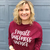 Amy Hallochak (owner, maker, designer) in a burgundy long-sleeve small business owner shirt.
